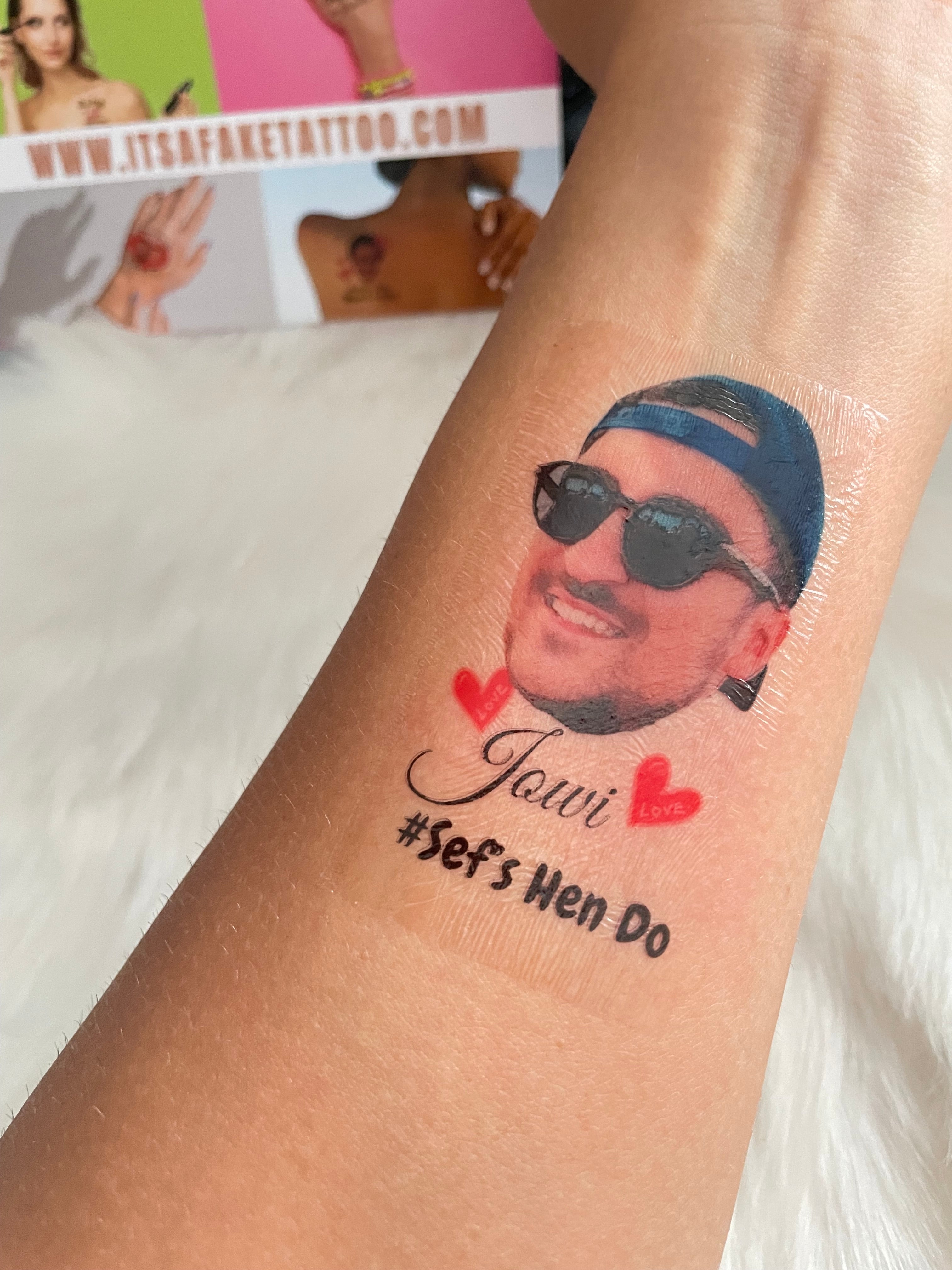 close-up portrait of handsome young man with fake tattoo sleeves on street  - Stock Image - Everypixel